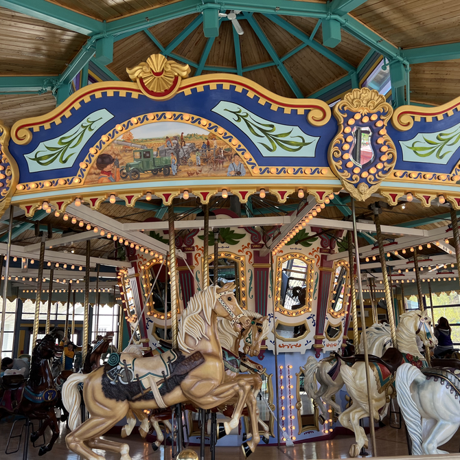 visitors riding the fort edmonton park carousel