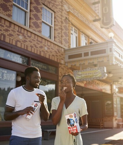 Couple walking on the boardwalk outside of the Capitol Theatre